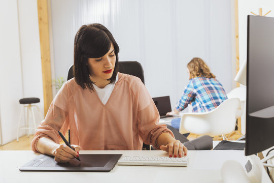 Young designer using devices for work