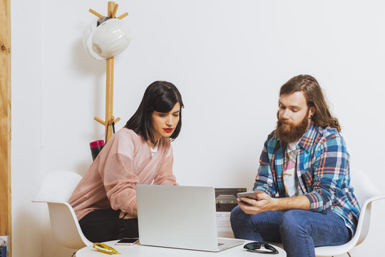 Hipster couple working at the office