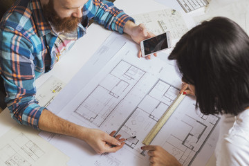 Team of designers working on blueprint