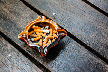 Bad addiction. Ashtray and cigarettes.