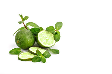 Lime. fruit with a half isolated on whiteFresh tasty lime fruit with mint leaves.