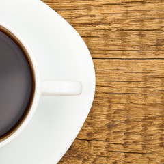 Close up shot of a cup of coffee on old wooden table