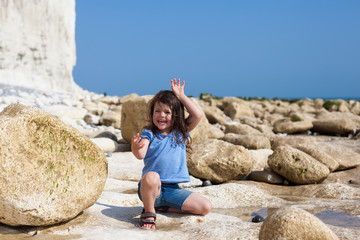 Little girl playing on English beach