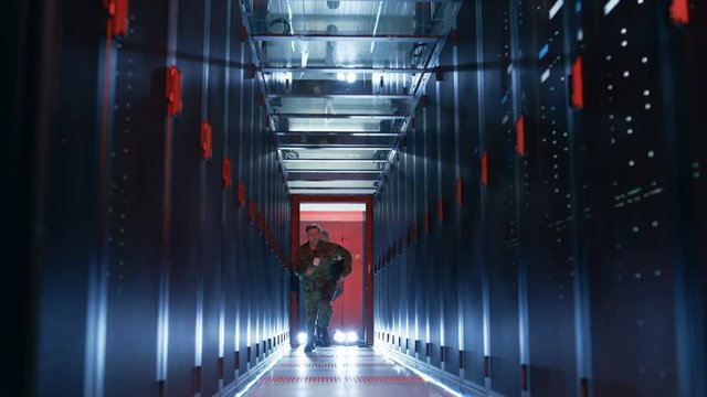 Security Alarm with Flasher Triggered in Data Center. Two Military Men Enter Sliding Doors and Run Through Corridor full of Server Racks.   Shot on RED EPIC-W 8K Helium Cinema Camera.