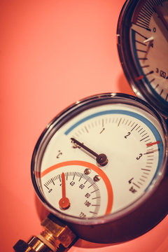 Pressure gauge on red background