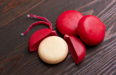 Round delicious cheese on wood