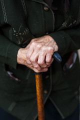 Hand of a senior woman holding a cane