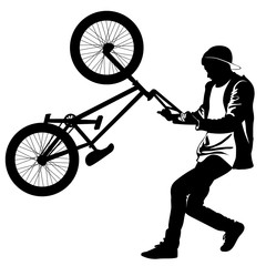 Silhouette of a teenager with a bicycle standing on the rear wheel
