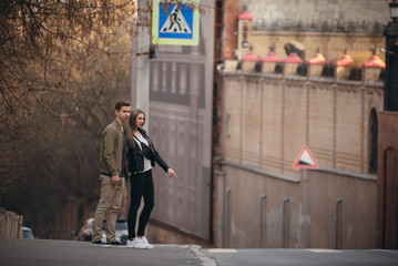 Couple has fun and laughs. kiss. Young hipster couple hugging each other in city.