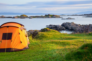 Camping tent on an ocean shore in a morning light