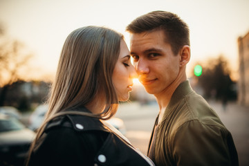 Couple has fun and laughs. kiss. Young hipster couple hugging each other in city.