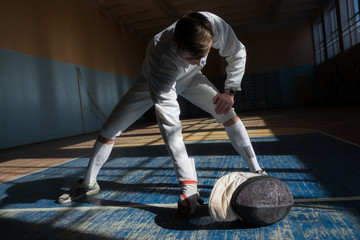 the fencer prepares for competitions. fencing coach. fencing sport motivation. mask and sword