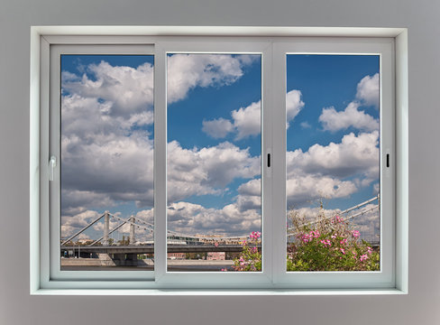 View of the Moscow city landscape through a triple window with sliding frames