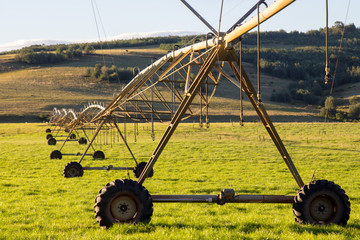 Irrigation equipment on green farm fields Sunset #6