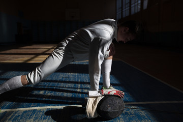 the fencer prepares for competitions. fencing coach. fencing sport motivation. mask and sword