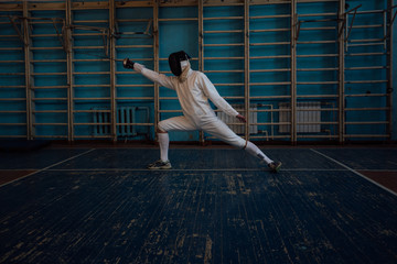 the fencer prepares for competitions. fencing coach. fencing sport motivation. mask and sword