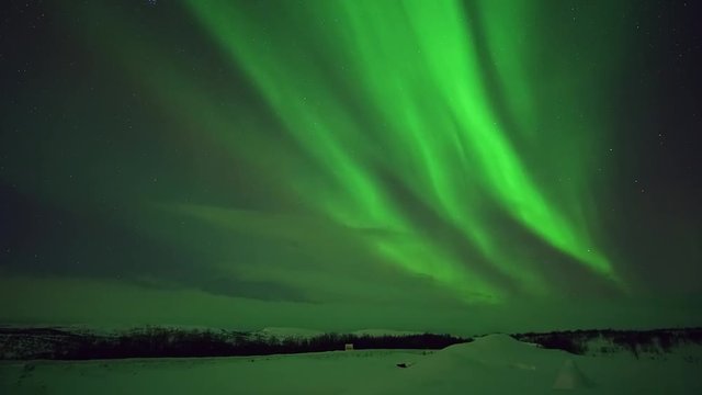 Northern lights Aurora borealis night stars sky. Northern pole winter snow cold. Green effect in the sky. Time-lapse movement beautiful color. Great moment bright