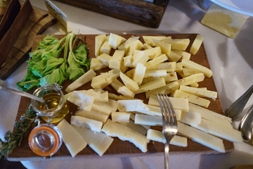 Traditional italian feta and cream white cheese with oil on a wooden plate ready for breakfast.