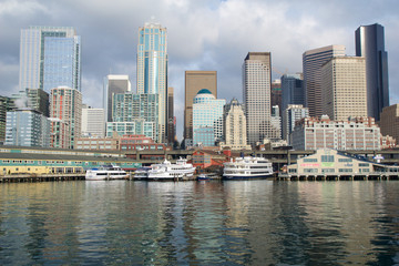 SEATTLE, WASHINGTON, USA - JAN 25th, 2017: A view on Seattle downtown from the waters of Puget Sound. Piers, skyscrapers in Seattle city before sunset