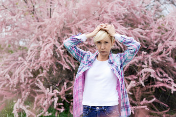 Vibrant blonde middle aged woman having a head ache - spring allergies