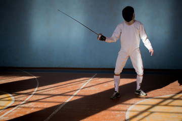 the fencer prepares for competitions. fencing coach. fencing sport motivation. mask and sword