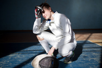 the fencer prepares for competitions. fencing coach. fencing sport motivation. mask and sword