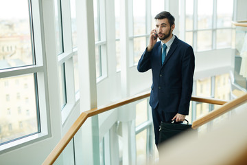 Elegant agent talking to client on the phone