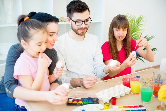 Family painting eggs