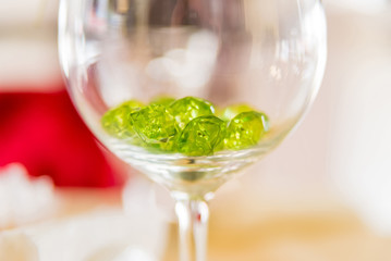 Close up green decorative crystals in glass