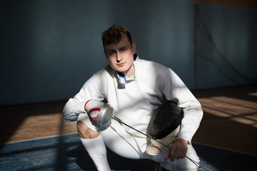 the fencer prepares for competitions. fencing coach. fencing sport motivation. mask and sword