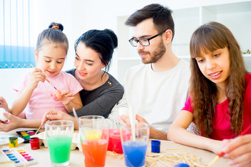 Family painting eggs