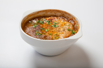 French onion soup in a deep white bowl.