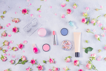 Colorful make up and roses top view flat lay scene