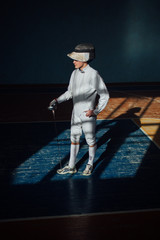 the fencer prepares for competitions. fencing coach. fencing sport motivation. mask and sword