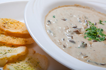 Mushroom cream soup with croutons, herbs and spices