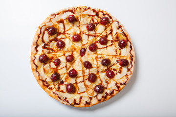 sweet apple pizza with sliced grape on white background