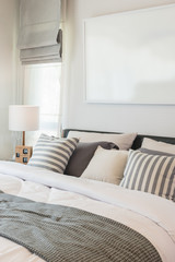 set of pillows and blanket on bed in modern bedroom