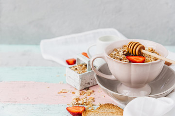 Oat flakes in bowl and fruits. Milk and honey. Wooden background. Top view