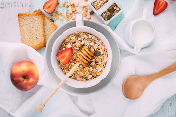 Oat flakes in bowl and fruits. Top view
