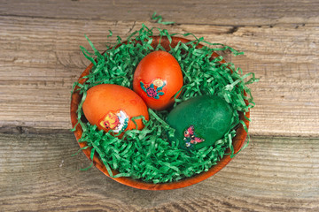 Colorful Easter eggs on old wooden table