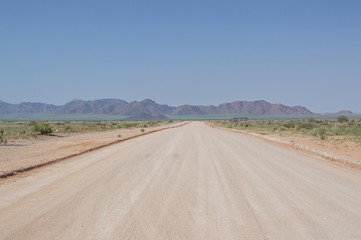 Dirt Road Highway in a Desert Landscape with Mountains in Solitaire, Namibia
