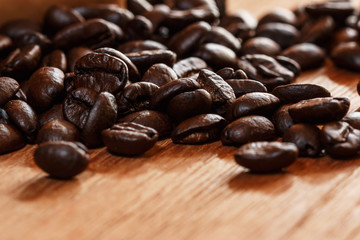 Roasted coffee beans espresso with a wood background