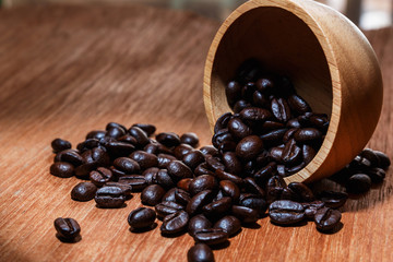 Roasted coffee beans espresso with a wood background