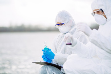 Scientists or biologists working together on water analysis.