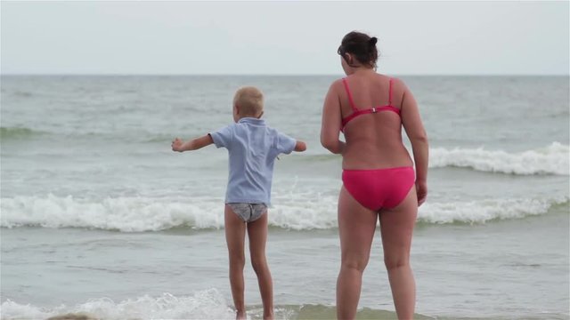 mother and son at sea/standing on the beach with his mother's son