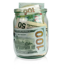 Glass jar with money on white background