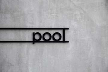 Black sign pool with cement wall