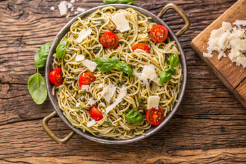 Spaghetti. Italian pasta spaghetti with basil pesto cherry tomatoes and olive oil.