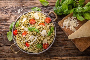 Spaghetti. Italian pasta spaghetti with basil pesto cherry tomatoes and olive oil.