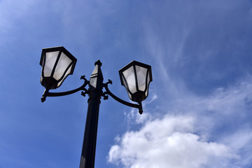 Fototapeta na wymiar Street lamp on blue sky background 